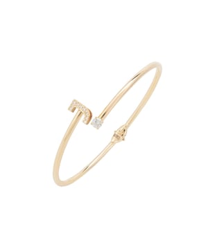 Design:This simple but beautifully styled initial bangle bracelet is perfect for those who covet delicate jewellery with a hint of sparkle, offering a sophisticated finishing touch to any outfit.Pretty and petite, this initial open cuff bangle features a hinge on the underside which makes it easy to put on and take off. The opening is designed to be on top of the wrist, where a zircon adorned monogram sits on one side and a single larger cubic zirconia resides on the other.What can be more personal than a name? Give this initial bangle bracelet as the perfect personalised birthday gift. Materials:Handcrafted using 925 sterling silver, dipped in 22ct gold. White cubic zirconia.Style Notes:Perfect pairing to the initial ring.Personalised birthday gift ideas. Bridesmaid gifts. Simple everyday styling.Dimensions:Bracelet: 19.5cm Packaging:This item is presented in a Latelita London signature jewellery box.Care Instructions:To maintain your jewellery, wipe gently with a damp cloth that is soft and clean. Do not soak in water. Avoid contact with soaps, detergents, perfume or hair spray.