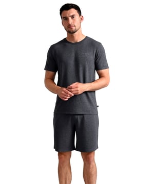 Introducing the Ted Baker Pyjama Shorts, the perfect addition to your nightwear collection. Made from a blend of 93% modal and 7% elastane, these shorts are incredibly soft and stretchy, providing maximum comfort and flexibility while you sleep. The fabric is also breathable, ensuring that you stay cool and comfortable all night long.Available in three sizes, medium, large, and x-large, and four colours, including charcoal, navy, burgundy, and green, these pyjama shorts are perfect for any style and preference. The classic design features an elasticated waistband with a drawstring for a secure and comfortable fit, and a relaxed fit for a comfortable and stylish look.One of the main benefits of these pyjama shorts is their high-quality material. The modal and elastane blend is not only soft and comfortable but also durable and long-lasting. This means you won't have to replace them as often, making them a cost-effective choice in the long run.In addition, the Ted Baker Pyjama Shorts are versatile, making them perfect for more than just sleepwear. You can wear them as comfortable loungewear or for light exercise. The classic design and variety of colours make them easy to style with any outfit.