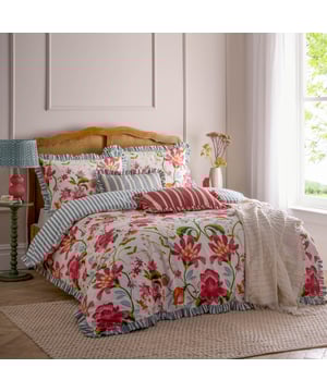 The Claudia Duvet Cover Set features a beautifully mirrored floral pattern with statement hand-painted flowers that delicately intertwine to create a seamless design. The striped reverse offers a classic look and the heritage striped ruffle trim adds an elegant touch. This floral bedding brings organic charm to your bedroom, making it the perfect addition to your decor this summer. 260 x 220cm