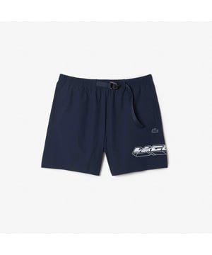Men’s Lacoste Quick Dry Logo Stripe Swim Trunks Elasticated waist with drawstring: Easy to wear  easy to adjust. Integrated mesh trunks: Breathable  for comfort. Logo stripe at waist  contrast print on leg: Eye-catching details. Two-tone silicone crocodile: A modern signature. Recycled polyamide: Limiting the use of new materials.