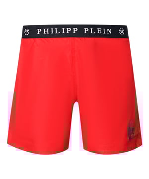 Philipp Plein Branded Waistband Red Swim Shorts. Be beach-ready in the Plein Red Swim Shorts. The plain branded waistband adds just the right amount of branding to the look. Enjoy your warm weather days with confidence and style.. Elasticated Waistband, Philipp Plein Red Swim Shorts. Branded Drawstring Fasten, branded Waistband, Skull Design On Left Leg. Medium Boardshort Style, 100% Polyester. Product Code - CUPP14M01 52