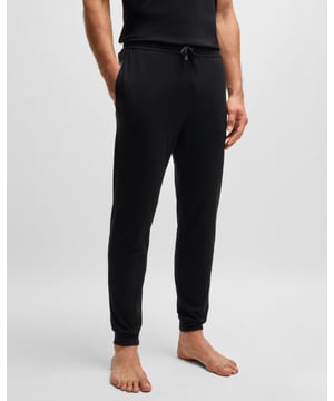 Regular-rise tracksuit bottoms by BOSS. Featuring branded cords and an embroidered logo, this cuffed pair comes in stretch jersey for comfort.

Covered waistband
Drawstring
Pockets bottom front: Side pockets

95% Cotton, 5% Elastane
50515365
