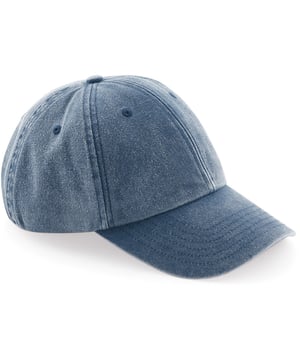 Laag profiel 6-paneel kap met denim-look opbouw. Zachte, ongestructureerde kroon. Vintage styling. Voorgebogen piek. Gestikte ventilatieopeningen. Zelfstofband met messing effectgesp. TearAway etiket voor gemakkelijk rebranden. Een maat. 100% Katoen.