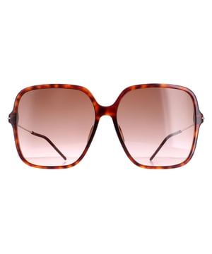 Gucci Square Womens Dark Havana Brown Gradient GG1267S  Sunglasses are a bold and fashionable accessory that will make a statement wherever you go. These sunglasses feature a unique square frame design crafted from a lightweight acetate frame. The iconic Gucci logo is prominently displayed on the temple, adding a touch of luxury to this already sophisticated design. Whether you're running errands, lounging on the beach, or dressing up for a night out, these Gucci GG1267S sunglasses will help you stand out from the crowd.