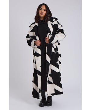 Model is 5'6 and wears a size 8. Longline. Large Fit. Borg. Dogtooth. Introducing our Dogtooth Borg Crombie Longline Jacket—where timeless elegance meets modern style. This jacket features a luxurious borg fabric that provides warmth and comfort, The classic Crombie design, combined with a contemporary twist, makes it a versatile piece perfect for elevating any outfit, from casual daywear to sophisticated evening looks.