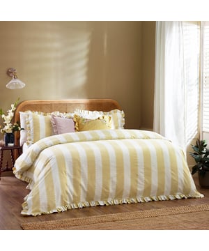 Bring a touch of elegance to your bedroom with the Birdie Stripe Ruffle Duvet Cover Set. Crafted from cotton-rich fabric with a 180 thread count, this duvet cover set offers a blend of comfort and style. The delicate ruffle trim nods to British heritage while adding a subtle hint of cottagecore charm. Its reversible design features classic stripes on both sides, offering versatility to match your décor. Designed for those who appreciate classic prints and patterns, this timeless bedding will become the centrepiece of your room, creating a serene retreat inspired by the natural world. 200 x 200cm