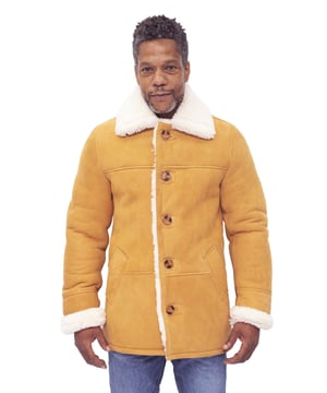Step into timeless elegance and superior comfort with our Men's Sheepskin Tan Leather Car Coat. Meticulously crafted from the highest quality double-faced sheepskin, this coat exudes sophistication and luxury. The exterior features a suede finish, adding a touch of refinement to the overall design. Inspired by the classic car coat style, it showcases notched lapels that exude timeless charm. The front is adorned with a five-button closure, creating a polished and distinguished look. Two handwarmer pockets at the waist offer both style and practicality. Additional design features include: • Premium double-faced sheepskin construction for exceptional durability and comfort. • Suede exterior finish for a luxurious and refined appearance. • Classic car coat design with notched lapels for a timeless appeal. • Five-button closure for a sophisticated and polished look. • Two handwarmer pockets at the waist for added convenience. Our Men's Sheepskin Tan Leather Car Coat is a testament to exquisite craftsmanship and unparalleled style. Embrace the epitome of elegance and warmth with this remarkable outerwear piece.  Genuine 100% Sheepskin Classic Car Coat 5 Button Front Comfort Fit