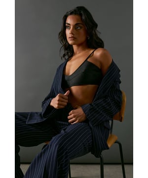 Luxurious heavy satin fabric for a sleek finish
        Strappy design with adjustable shoulder straps
        Seaming detail for a flattering shape
        Deep V-neckline for a daring look
        Versatile piece for layering or wearing alone
    
    This Warehouse Heavy Satin Strappy Seaming Bralette is the epitome of confident, edgy femininity. The lustrous satin fabric catches the light beautifully, creating a sophisticated sheen that's perfect for special occasions. The strategic seaming accentuates your curves, while the strappy design adds a touch of allure. Style it under a sleek blazer for a bold twist on formal attire, or pair it with high-waisted trousers for a chic evening ensemble. For a more daring look, wear it as a standalone top with a maxi skirt or wide-leg trousers. This versatile bralette is ideal for cocktail parties, gallery openings, or any event where you want to make a statement. Its adaptability allows for both refined and avant-garde styling, making it a must-have piece for the fashion-forward woman who isn't afraid to stand out.