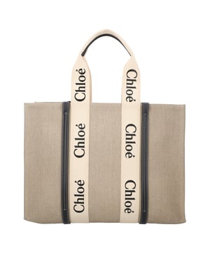 Tote bag in linen canvas &amp; shiny calfskin with Woody ribbonCarry: shoulder &amp; hand
- 2 long handles- 1 spacious main compartment- 1 internal flat pocketComes with a dust bag
- Width: 17.7" (45 cm)- Height: 13" (33 cm)- Depth: 5.2" (13 cm)- Strap length/ handle drop: 9.8" (25 cm)