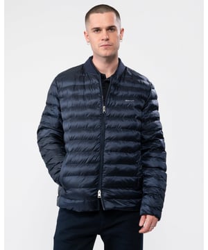 Crafted in a lightweight polyester with a water-repellent finish, this fully lined padded bomber jacket acts as an extra layer of style when you need a little more warmth. Featuring a length that falls just above the hip, front zip closure and straight channel quilting, this piece is perfect for cooler mornings or outings after sundown.
Regular fit  Ribbed bomber collar  Welt pockets with snap closure, interior pocket  Water-repellent
 
Shell - Recycled Polyester 100%Lining - Recycled Polyester 100%
 
7006300
 
