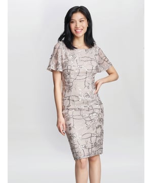 Adorned with iridescent sequins and embroidered floral embroidered details allover its length, this dress shows off a jewel neckline and framed with short flutter sleeves. Defined with a deep v-open back, the sheath skirt sculpts elegantly into a knee length hemline.