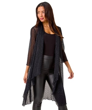Shimmer Plisse Longline Kimono from Roman. Wrap up in style this Autumn/Winter with this gorgeous plisse longline kimono. Featuring a striking chevron metallic print and crafted from stretch plisse fabric, this kimono exudes elegance. With a flattering longline length, long sleeves, and an edge to edge design, it's perfect for layering over any outfit. The waterfall front adds a touch of sophistication. Pair it with a simple t-shirt and PU trousers for a chic and on trend look!