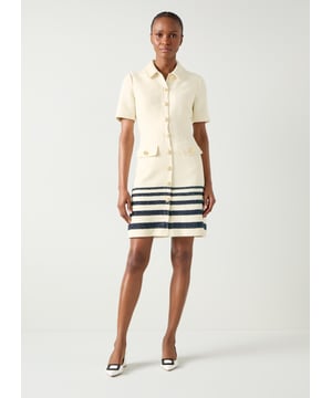 The Bellmer tweed dress offers a perfect mix of traditional elegance and modern style. Crafted from Italian cotton, this smart casual attire features a stripe placement in cream and spring vy tweed. It includes a collared neckline and full length sleeves, highlighted by metal weave effect buttons. Ideal with sleek heels or ballet flats, this dress transitions smoothly from office settings to evening engagements.