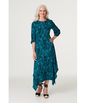Add an chic asymmetric style to your dress collection with this chic paisley midi. It has a round neck, 3/4 sleeves, a keyhole back, a cinched waist and an elegant midi length skirt with a hanky hem detail. Pair with neutral heels for a daytime style you can wear for anything from lunch with the girls to a day at the races.