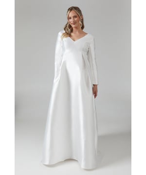 Elegant V-neckline adorned with delicate faux pearl detailing
        Long sleeves for a sophisticated and timeless look
        Empire waistline to flatter the growing bump
        Floor-length design with a graceful A-line silhouette
        Versatile twill fabric for comfort and style
    
    This stunning maternity wedding dress from Coast is the epitome of bridal elegance. The V-neckline, embellished with faux pearls, adds a touch of romance and sophistication to your special day. The empire waistline gracefully accommodates your changing figure, while the floor-length A-line silhouette creates a flowing, ethereal look. Perfect for the expectant bride, this dress can be styled with a delicate tiara and drop earrings for a regal appearance. Consider pairing it with comfortable yet stylish low-heeled sandals to ensure comfort throughout your celebration. This versatile gown is not only ideal for your wedding ceremony but can also be worn for pre-wedding events or styled differently for other formal occasions during your pregnancy, making it a treasured piece in your maternity wardrobe.