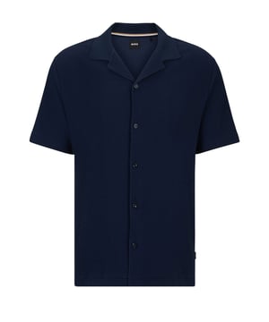 Boss Powell 129 Button Through Polo Shirt Dark Blue
Bring some of that resort feeling this summer with this shirt/polo hybrid from BOSS. Made from a cotton jersey woven with a unique texture. The resort style collar is functional and on trend for this season. Wear with shirts, linen or chinos for that perfect summer look.

Cotton
Resort Collar
Regular fit 
Style 50513055