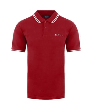 Ben Sherman Twin Tipped Men's Red Polo Shirt, a classic and iconic garment that embodies the timeless style and sophistication that the brand is known for. Elevate your wardrobe with this vibrant and stylish polo shirt, perfect for adding a pop of color to your casual or semi-formal outfits.

Key Features:

 Premium Quality Material:  The Ben Sherman Red Polo Shirt is crafted from high-quality cotton fabric, offering exceptional comfort, breathability, and a soft touch against the skin. Experience the luxury of superior craftsmanship with every wear.

 Iconic Twin-Tipped Design:  The signature twin-tipped detailing on the collar and cuffs is a hallmark of Ben Sherman's renowned style. The subtle contrast trim adds a touch of elegance, setting this polo shirt apart from the rest.

 Vibrant Red Shade:  The striking red color exudes confidence and energy, making a bold statement wherever you go. This attention-grabbing hue is sure to garner compliments and turn heads.

 Flattering Fit:  Designed to complement various body types, the Ben Sherman Polo Shirt features a tailored silhouette that enhances your physique without compromising on comfort.

 Versatile Wardrobe Staple:  This red polo shirt effortlessly transitions between casual and semi-formal settings. Whether you pair it with jeans, chinos, or shorts, it creates a stylish look for a range of occasions.

 Embroidered Brand Logo:  The discreetly embroidered Ben Sherman logo on the chest showcases the brand's heritage and commitment to quality, guaranteeing an authentic and genuine product.

 All-Season Wear:  Suitable for year-round wear, this polo shirt adapts to different weather conditions, making it a versatile and practical addition to your clothing collection.
