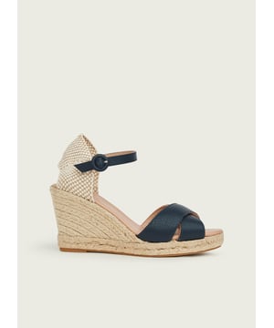 Immediately conjuring up holiday memories, an espadrille sandal is a summer classic, and our new Angela wedges are designed for all your sun-soaked adventures. Crafted in Spain from super-soft navy blue suede, they have a knot front, a buckled ankle strap and a 90mm espadrille wedge heel. Wear them with shorts and a tee or your favourite sun dress when the temperatures rise. 