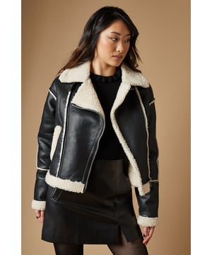 Striking contrast borg detailing for added warmth and style
        Asymmetrical zip front closure for a modern edge
        Oversized collar for a bold, fashion-forward look
        Cropped length perfect for layering
        Versatile design suitable for various casual occasions
    
    This PU borg detail collared zip jacket from Oasis is the epitome of cool-weather chic. The contrasting borg lining not only adds a cosy touch but also creates a striking visual appeal. Its asymmetrical zip closure and oversized collar lend a contemporary edge to your ensemble. The cropped silhouette is ideal for showcasing high-waisted bottoms, as demonstrated by the model pairing it with wide-leg trousers. For a casual day out, style it with your favourite jeans and trainers. Alternatively, dress it up for an evening with friends by layering it over a fitted dress and ankle boots. This jacket is a versatile piece that will quickly become a go-to in your autumn and winter wardrobe, perfect for family gatherings, weekend brunches, or casual outings where you want to make a stylish statement without compromising on comfort.