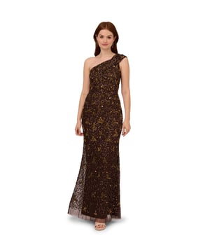Hit every red carpet in this unforgettable one-shoulder gown. This beaded gown features a one-shoulder bodice, an extended cap sleeve, and a mermaid skirt. Crafted from a mesh knit fabric and fully lined, this formal dress is hand-embellished with a sparkling mix of sequins and beading. A zipper at the side of the dress closes the look. Step into a neutral high heel and add statement earrings to complete this evening gown.