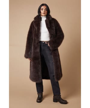 Luxurious faux fur texture for ultimate comfort and style
        Midi length design for versatile wear
        Oversized fit for a contemporary silhouette
        Plush collar adds a touch of glamour
        Side pockets for practicality and hand warmth
    
    Wrap yourself in the sumptuous embrace of this faux fur midi coat from Oasis. Perfect for those who adore a feminine touch with a dash of drama, this coat is a statement piece that seamlessly transitions from day to night. The oversized fit allows for effortless layering over your favourite ensembles, while the plush texture adds a luxurious feel to any outfit. Style it with sleek trousers and a crisp white turtleneck for a chic office look, or throw it over a floral dress for an evening out. The versatility of this coat makes it an ideal choice for various occasions, from casual weekend brunches to more formal events. Its ability to be dressed up or down ensures it will become a cherished staple in your wardrobe, ready to add a touch of sophistication to any ensemble.