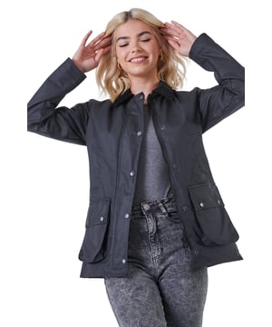 Checked Lined Wax Coat from Roman. Chic and comfortable this short waxed jacket is as fashionable as it is practical. Made from a 100% cotton fabric finished with a protective waxed coating this is sure to keep you dry. Its short length keeps it light and cool. It features a contrast, cord collar and useful pockets with secure popper fastenings. It has a full front zip opening with popper overlay for extra security. It’s finished off with a heritage check inner lining. Pair with knitwear and denim for walks with friends!