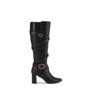 This Kurt Geiger Mayfair Strappy Knee high boot is crafted from a soft black leather with  strap detail up the entire shaft. There are two antiqued brass buckles with eagle heads across the straps. Heel height: 8cm.