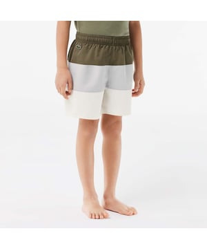 Colourblock Swim Trunks Recycled polyester made from manufacturing offcuts Elasticated waist Contrast Lacoste print Sewn-on embroidered crocodile below waistband  Colourblock Swim Trunks Recycled polyester made from manufacturing offcuts Elasticated waist Contrast Lacoste print Sewn-on embroidered crocodile below waistband