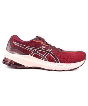 Baskets rouges à lacets Asics Gt-1000 10 pour femme avec respirabilité. empeigne en mesh technique. bandes latérales emblématiques et détails réfléchissants. Ces chaussures de course légères et performantes sont conçues pour la surpronation et sont dotées de la technologie GEL™ offrant stabilité et confort à chaque foulée.