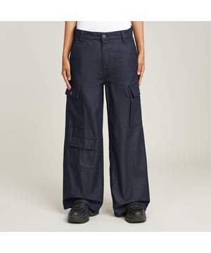 Zip fly. Inset pockets and coin pocket, rivet reinforced corners. Flap pockets with a button closure at the thigh, lower front and back. G-Star RAW label at the back, made from a leather-like paper fabric. Zip & button closure. Low waist. Denim cargo pants Mega show a low waist on a loose fit with straight legs. Multiple 3D flap pockets are created at the front. Also at the back pockets are created, showing only a flap and button. A coin pocket is placed in one of the inset pockets. Rivets reinforce the corners. 100% Cotton. Rigid. Denim, weight 9.6 oz. Loose