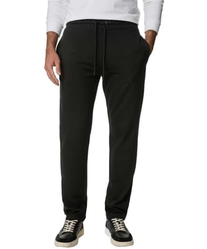 The Kruze Open Hem Joggers offer the perfect blend of comfort and functionality. Designed with an open hem for a laid-back look, these joggers feature a ribbed, elasticated waistband with adjustable drawstrings for a secure, customized fit. Practicality is ensured with two concealed side zip pockets and a single back zip welt pocket, providing secure storage for your essentials. Crafted with soft fleece lining, these joggers promise warmth and comfort, making them ideal for both lounging and casual outings