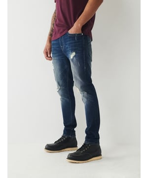 Meet our ultra-slim Jack Jean. This distressed men's super skinny jean features fading, 3D whiskering, and ripped destruction. Finished with two tone stitching, 1/2" horseshoe detailing along the back pockets, and a shorter 30" inseam.