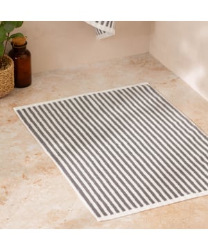 Elevate your bathroom with the Hebden Striped Cotton Bath Mat, crafted from 100% cotton terry for an irresistibly soft feel underfoot. Combining a timeless striped design with versatile contemporary shades, it brings a perfect balance of classic and modern style to your space. Designed to create a cool, calming atmosphere, this bath mat promises more than just style—it enhances your sense of comfort and wellbeing. Durable and naturally breathable, it offers practicality to match its beauty, making it an essential finishing touch to your home environment.