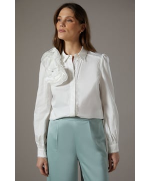 Striking 3D floral appliqu detail on the collar
        Elegant collared neckline with button-up front
        Long sleeves with subtle puff at the shoulders
        Cropped length for a modern silhouette
        Textured fabric adds depth and visual interest
    
    Make a statement at your next special occasion with this exquisite 3D Flower Shirt from Coast. The eye-catching floral appliqu adorning the collar creates a dramatic focal point, perfect for those who appreciate unique details. The cropped length and textured fabric combine to create a contemporary look that's both sophisticated and on-trend. Style this versatile piece with wide-leg trousers and strappy heels for a chic ensemble at weddings or race days. For a more relaxed yet equally stylish look, pair it with tailored shorts and elegant flats for summer garden parties. The shirt's crisp collar and button-up front allow for styling versatility - wear it fully buttoned for a polished appearance or leave the top buttons undone for a more relaxed vibe. This Coast shirt is a true wardrobe gem that will have you standing out from the crowd at any event.