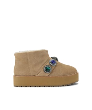 This Kurt Geiger Octavia Teddy Bootie is crafted from a soft beige suede. There is a statement strap going across the ankle which features multi-colour crystals. The sole is pumped up for extra impact.
