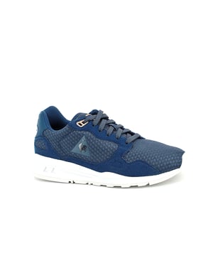 Elevate your athleisure style with the Le Coq Sportif R900 Mesh Women's Blue Trainers, a perfect blend of fashion-forward design and athletic performance. These trainers are designed to provide comfort, support, and a touch of elegance, making them an ideal choice for both sports activities and casual outings.

Key Features:

 Breathable Mesh Upper:  The R900 Mesh trainers feature a lightweight and breathable mesh upper that ensures proper ventilation, keeping your feet cool and comfortable during extended wear. This makes them suitable for various activities, including workouts and everyday wear.

 Sleek Design:  Le Coq Sportif is known for its attention to aesthetics, and the R900 Mesh trainers are no exception. The sleek design, combined with the blue colorway, offers a sophisticated look that effortlessly complements a wide range of outfits.

 Cushioned Insole:  These trainers are equipped with a cushioned insole that provides a plush feel underfoot. The added padding helps absorb impact and offers a responsive bounce, making your steps feel light and comfortable.

 Supportive Structure:  The trainers feature a supportive structure that cradles your feet, providing stability during lateral movements and ensuring a secure fit. This support is essential for various activities, including gym workouts and light running.

 EVA Midsole:  The R900 Mesh trainers come with an EVA midsole that offers excellent shock absorption properties. This feature helps reduce strain on your joints and allows you to go the extra mile with less fatigue.

 Le Coq Sportif Logo:  Look for the iconic Le Coq Sportif logo subtly placed on the trainers, adding a touch of brand recognition and authenticity to your footwear.

 Durable Outsole: