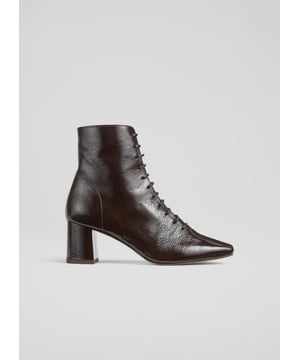 Experience sophistication with every stride. Our Arabella lace-up ankle boots in rich espresso crinkled patent boast a stylish square toe and a sturdy block heel, all exquisitely lined with leather. Perfect for smart-casual ensembles, pair them with tailored trousers or your favourite dress. These lace-up ankle boots are the epitome of style and function. Made in Spain.