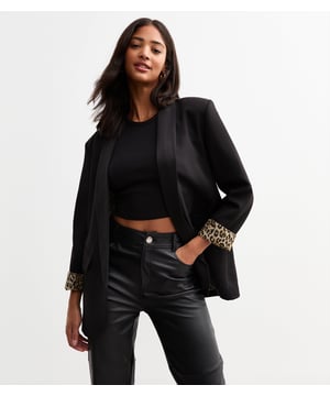 Elevate your style with our sleek Black Contrast Animal Edge to Edge Blazer. Stand out with its unique animal print contrast, perfect for the fashion-forward woman. This versatile blazer can be dressed up or down, making it a stylish addition to any wardrobe.