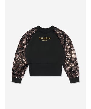 Balmain incorporate sleek, opulent silhouettes into their enigmatic abstracts. This girls black gold sweatshirt is a captivating piece to adore. Envisioned in beautiful high quality cotton jersey, showcasing 'Balmain Paris' gold embroidery and velvet multicolour sequin long sleeves. Complete with an elasticated waistband, she will be obsessed.  Ribbed Trims  Round Neck  100% Cotton Embroidery: 60% Polyamide, 40% Polyester