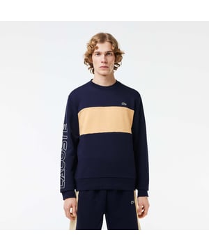 Color combination and graphics for a Lacoste dynamic and creative identity. Classic fit  natural ease on body with comfortable sleeves Our classic French terry Cut & sewn colorblock crew neck sweatshirt in mix of two different colors Rib at sleeves and bottom of body 3cm green crocodile at chest Lacoste wording 3D print at right sleeve.