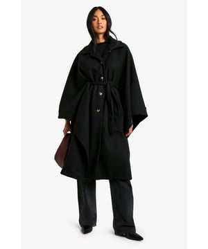 Dramatic cape-style silhouette for a bold statement
        Oversized collar adds a touch of sophistication
        Belted waist for a customisable fit
        Functional side pockets for practicality
        Versatile length suitable for various outfits
    
    Make a striking entrance with this captivating cape in wool-look fabric. Perfect for the fashion-forward woman who craves both style and comfort, this piece effortlessly combines drama with versatility. The oversized collar and flowing silhouette create an air of elegance, while the belted waist allows you to customise your look. Ideal for casual outings or family gatherings, pair it with wide-leg trousers and a simple top for a chic ensemble. The side pockets add a practical touch, making it perfect for those days when you want to travel light. Whether you're heading to a coffee date or a weekend market, this cape will ensure you stand out from the crowd while keeping you cosy. Its adaptable nature means it can be dressed up or down, making it a valuable addition to any wardrobe.