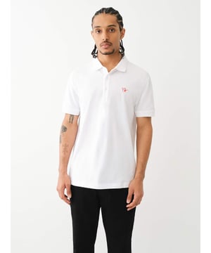Pop that collar with the Buddha Patched Logo Polo Shirt. Crafted from soft cotton, this men’s polo features a basic collar. half-button placket, and short sleeves. Finished with a relaxed fit, ribbed trim, and a chest Buddha patch.
