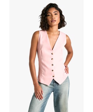 Sleek collared waistcoat with a plunging V-neckline
        Five-button front closure for adjustable fit
        Tailored regular fit for a classic silhouette
        Versatile sleeveless design perfect for layering
        Crafted from lightweight poly crepe fabric
    
    Make a bold statement with this chic Tall Weste from Boohoo. This sleeveless waistcoat is the epitome of versatile style, seamlessly transitioning from day to night. For a trendy daytime look, pair it with wide-leg jeans and trainers, adding a tote bag for a casual yet put-together ensemble. When the sun sets, transform your outfit by buttoning up the waistcoat and teaming it with tailored trousers and strappy heels. The plunging neckline adds a touch of allure, perfect for those nights out on the town. Whether you're meeting friends for drinks or hitting the dance floor, this waistcoat will ensure you stand out in the urban nightlife scene. Its adaptable nature makes it a must-have piece for the fashion-forward woman who values both style and practicality.