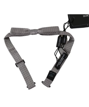 Merk: Dolce & Gabbana
  Kleur: Grijs stippenpatroon
  Model: Gebonden
  Materiaal: 100% Zijde
  Breedte: 2cm
  Verstelbare nekband
  Een maat voor iedereen
  Gemaakt in Italie