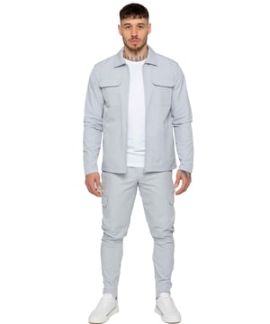 Enzo Mens Cargo Shacket Tracksuit Set. Zip Up Cargo Collared Shacket. Features Front Upper Cargo Pockets, Long Set in Sleeves, Stitched Trims on Cuff &  Hem. Set Completed With Cargo, Straight Leg, Slim Fit Trousers. Elasticated Waistband With Adjustable Drawstring. Two Slash Side Zip Pockets, Single Back Welt Pocket, Two Outer Cargo Pockets. Crafted With Premium Stretch Material. Modern, Stylish & Comfortable.
