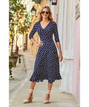 REASONS TO BUY:

The dress that feels as good as it looks
Super-comfy fabric
Chic navy polka dot print
Flattering V-neck and waist tie
Feminine ruffle hem
We're wearing it with a white blazer and wedges