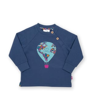 72 days and 25,000 miles later, Nellie Bly successfully circumnavigated the globe. This around the world sweatshirt is inspired by this incredible journey, which Nellie undertook to beat the popular fictional Jules Verne book “Around the World in Eighty Days”. Stylish and practical, with a lovely hot air balloon appliqué on super-soft navy blue brush back sweat fabric.