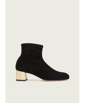 An elevated take on a classic stretch suede boot, our Grace ankle boots are treated to a chic gold heel. They're crafted in Spain from black stretch suede, which we've greatly improved with double the amount of stretch to fit and feel so much better on the leg. The gold block heel adds glamour and the almond-shaped toe complements the sleek, sock-like silhouette. Wear them with tailored trousers or with tights and skirts when the weather cools off.