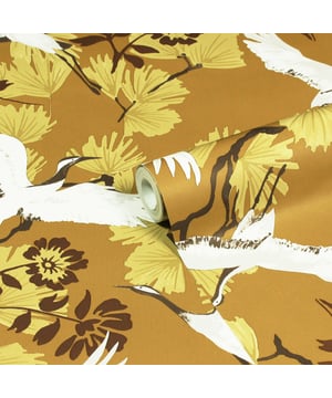 Glide through the air with the majestic birds soaring through tropical foliage with the Demoiselle wallpaper. These Exotic birds fly over an array of quirky leaves in a stunning range of hues and intricate detailing, will make a statement in whichever room you put it in. This wallpaper is a paste the wall application; simply paste the wall, hang your paper, and leave to dry. Each roll is 10m long and 52cm wide. Pattern repeat: 53cm Straight match. Our Demoise wallpaper can be used to paper the whole room or to create an eye-catching feature wall. This wallpaper is also wipeable so that any light marks can be dabbed away.