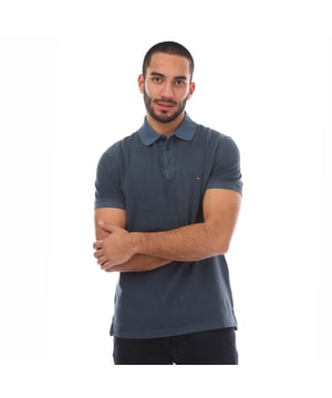 Mens Tommy Hilfiger Garment Dye Regular-Fit Polo Shirt in blue.- Polo collar.- Short sleeves with ribbed cuffs.- Partial button placket.- Embroidered chest flag.- Regular fit.- Ref: MW0MW34757DAF